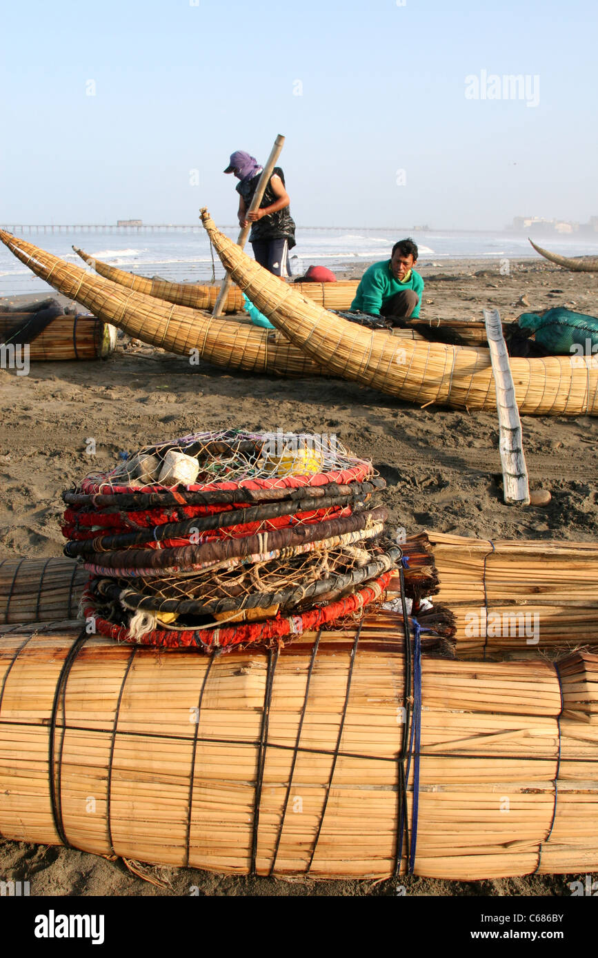 Locals prepare a fishing net to catch fish in the lagoon at Lepa