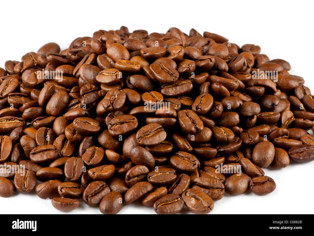 Brown roasted coffee beans isolated on white background Stock Photo - Alamy