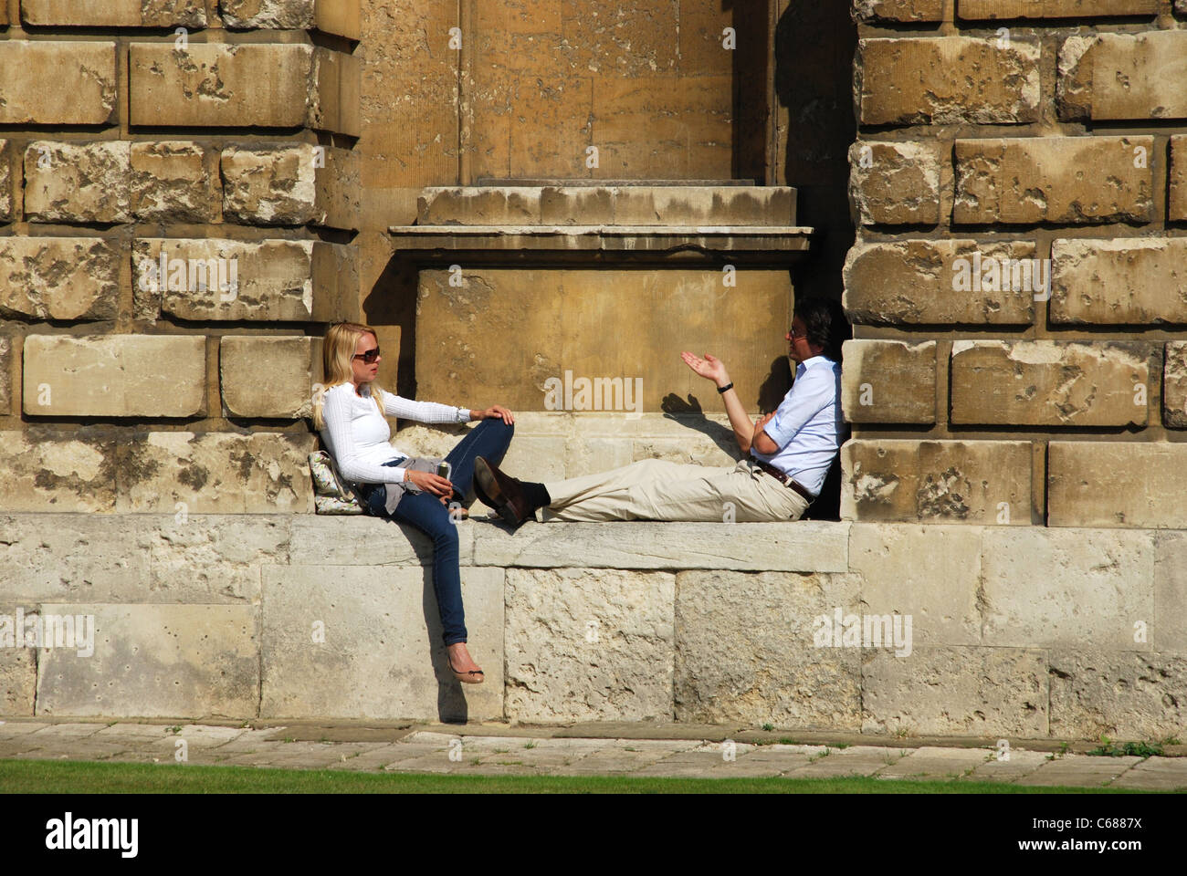 two students talking and relaxing at Radcliffe Camera Oxford UK Stock Photo