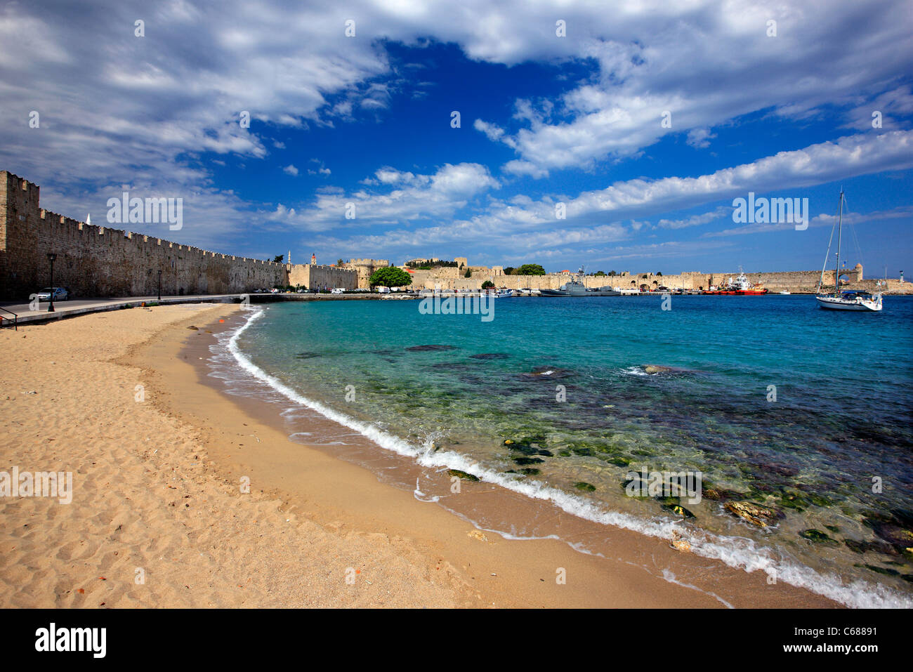 The sandy beach and  the seaside walls, at Sahtouri coast,   Medieval town of Rhodes (World Heritage site by UNESCO), Greece Stock Photo