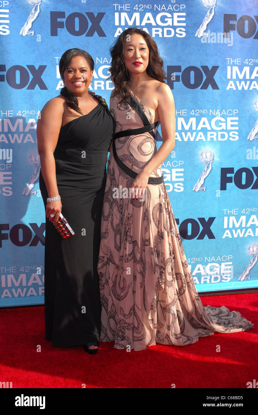 Chandra Wilson, Sandra Oh at arrivals for 42nd NAACP Image Awards, Shrine Auditorium, Los Angeles, CA March 4, 2011. Photo By: Elizabeth Goodenough/Everett Collection Stock Photo