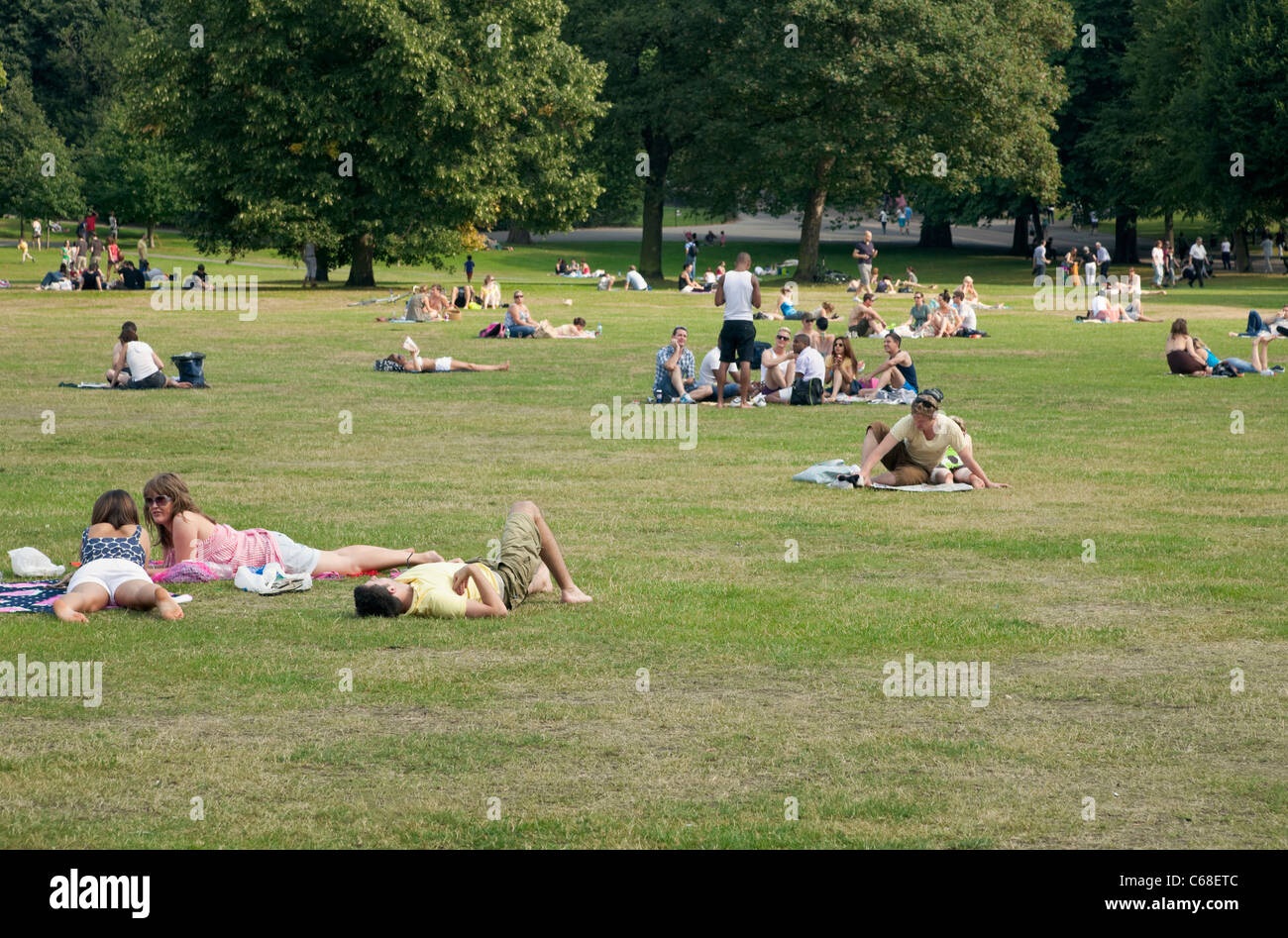 People Enjoying The Sunshine In Greenwich Park,London,UK Stock Photo