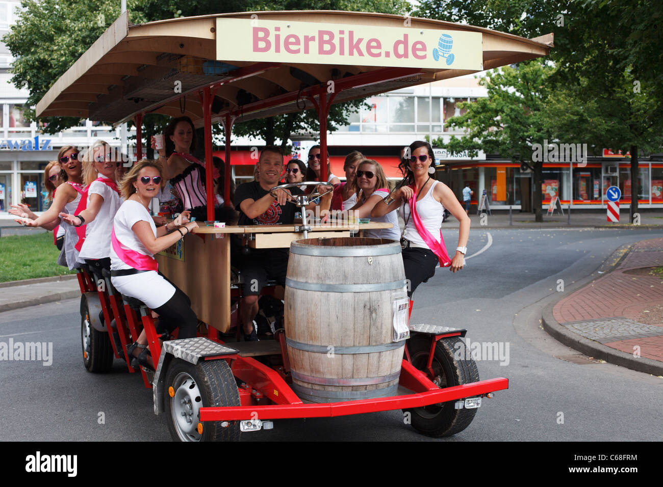 Young women pedal a bier bike in Hanover, Germany. Stock Photo