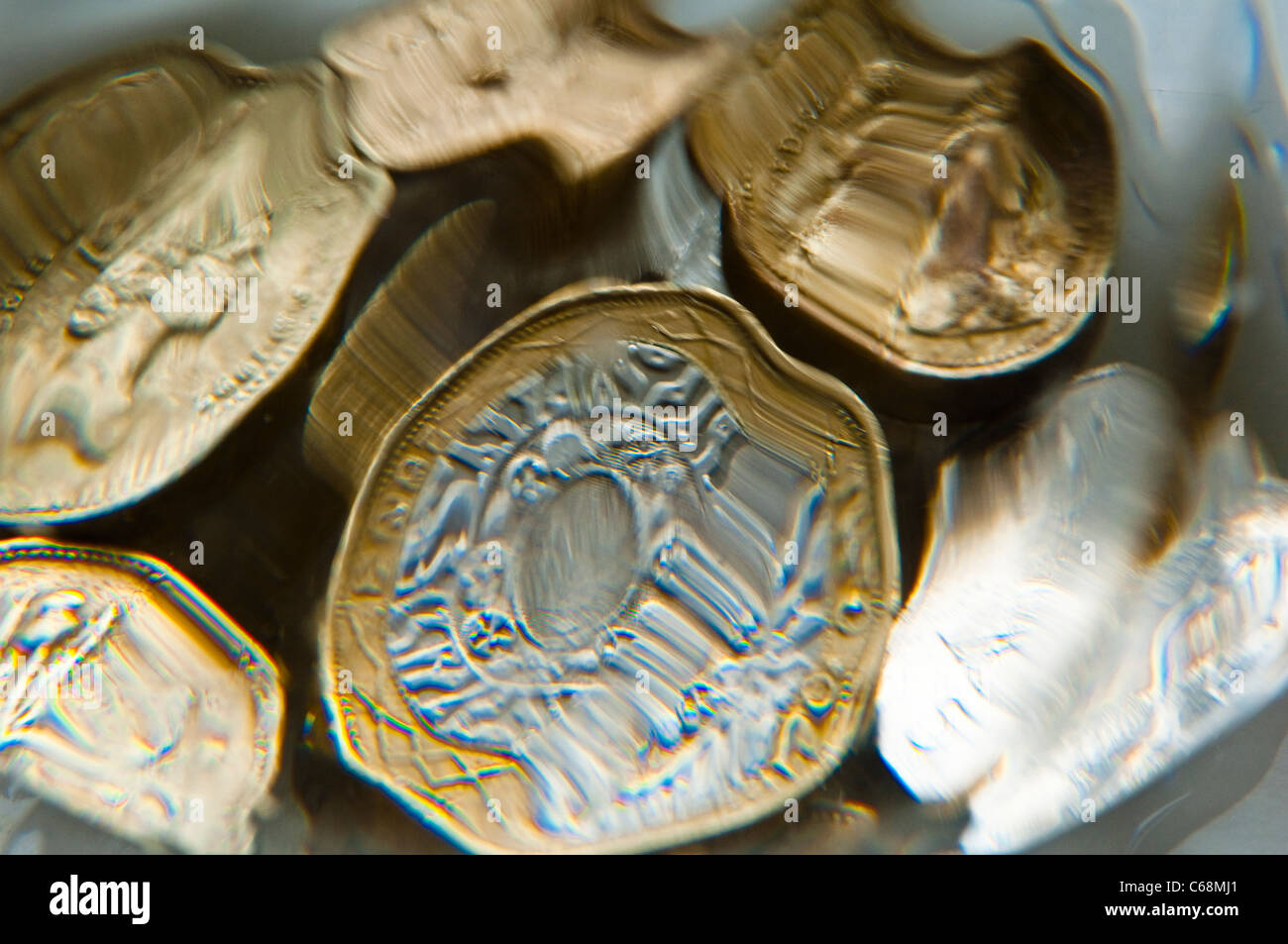 Blurred and distorted view of UK Coins. £1 pound, £2 pounds and 50p pence. Stock Photo