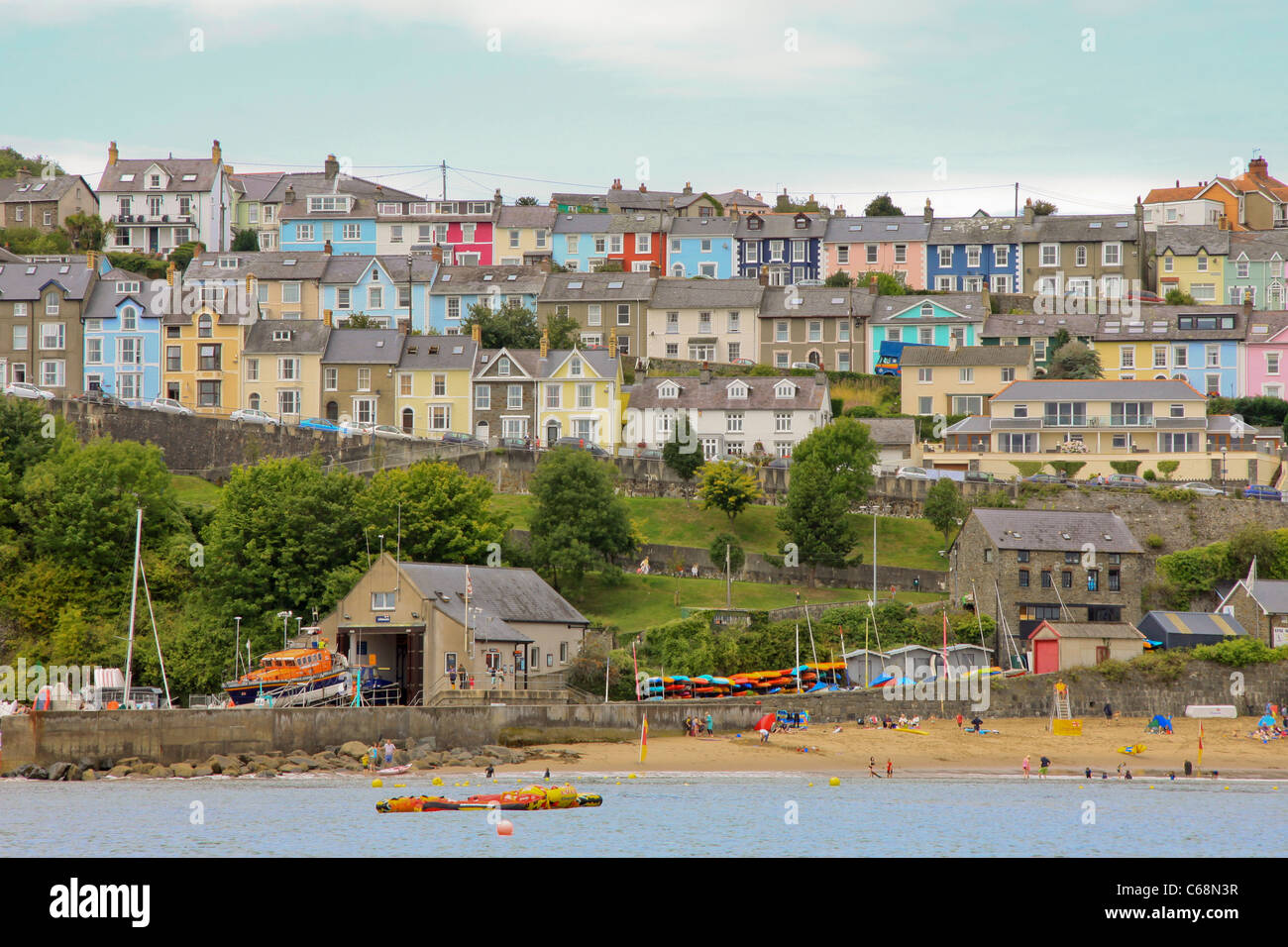 Rows of coloured houses over looking the sea in New Quay, Wales Stock Photo