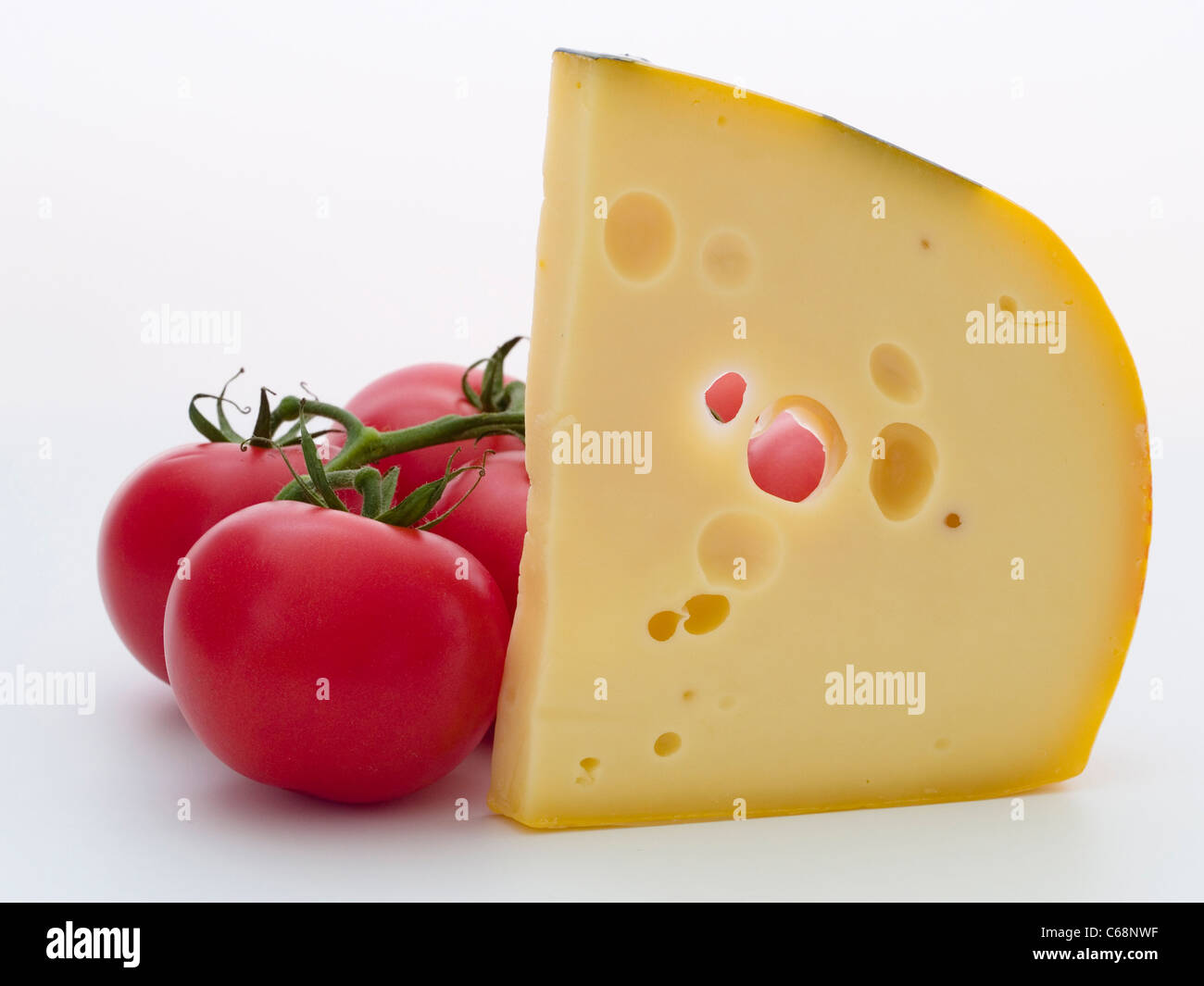 ein Stück Käse und Tomaten | a piece of cheese and tomatoes Stock Photo