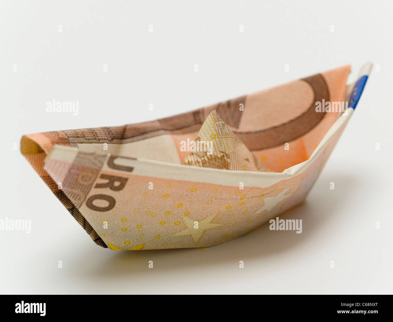 ein 50 Euro Schein zu einem Boot gefaltet | one 50 euros banknote folded to a boat Stock Photo