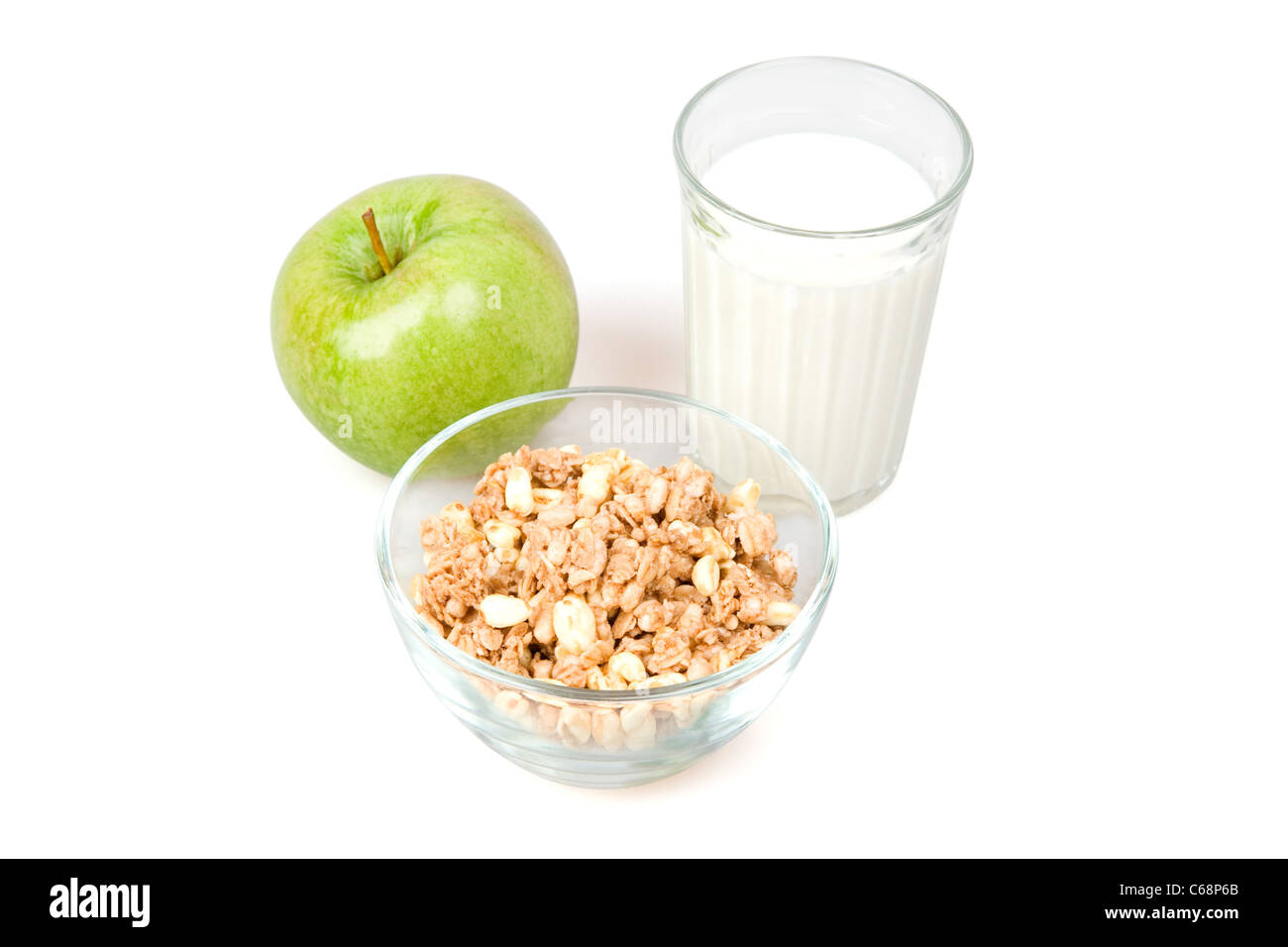 Muesli, milk and green apple is isolated on a white background Stock