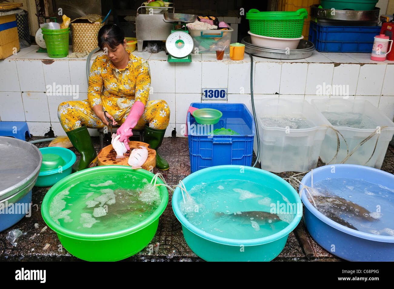 Women Preparing Fresh Fish on a Seafood Stall in Ben Thanh Market, Ho Chi Minh City, Saigon