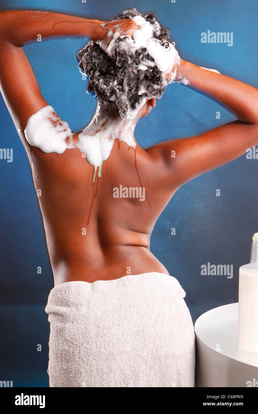 Cute African American washes her hair and turns her back to the camera Stock Photo