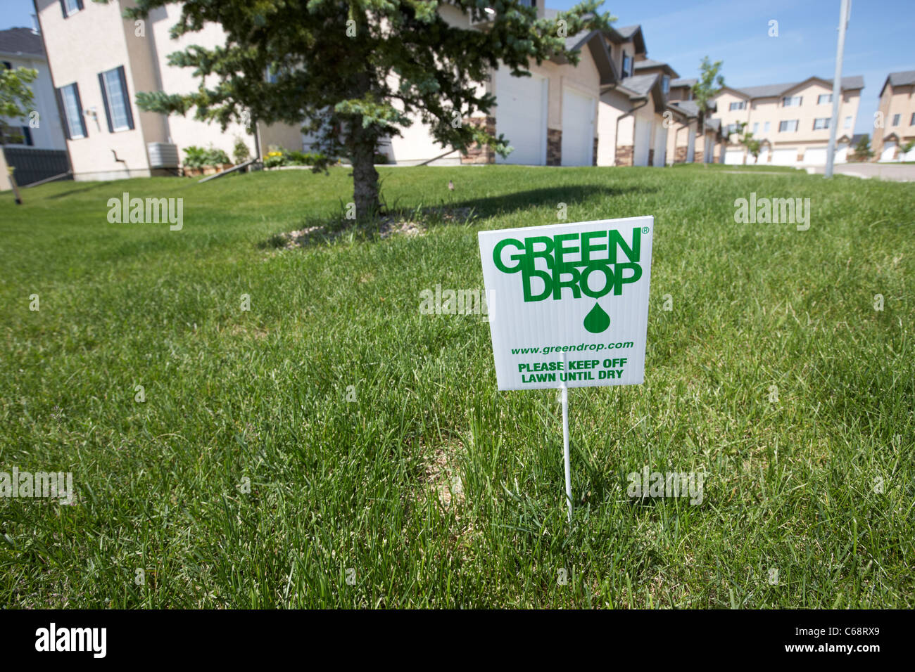 green drop sign to keep off the lawn until dry on managed condominium