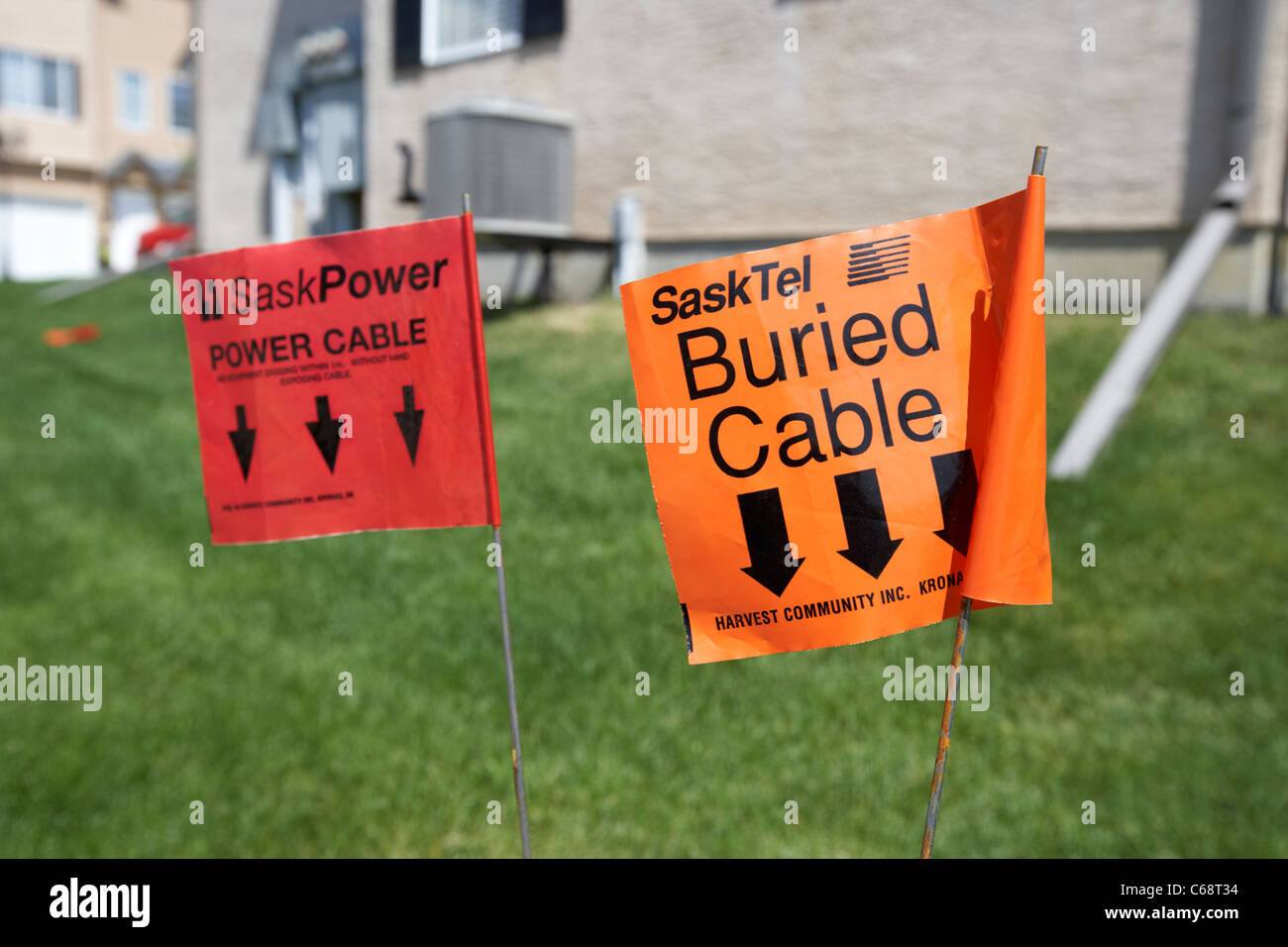 warning flags for power and telephone cables buried underground on managed property Saskatoon Saskatchewan Canada Stock Photo