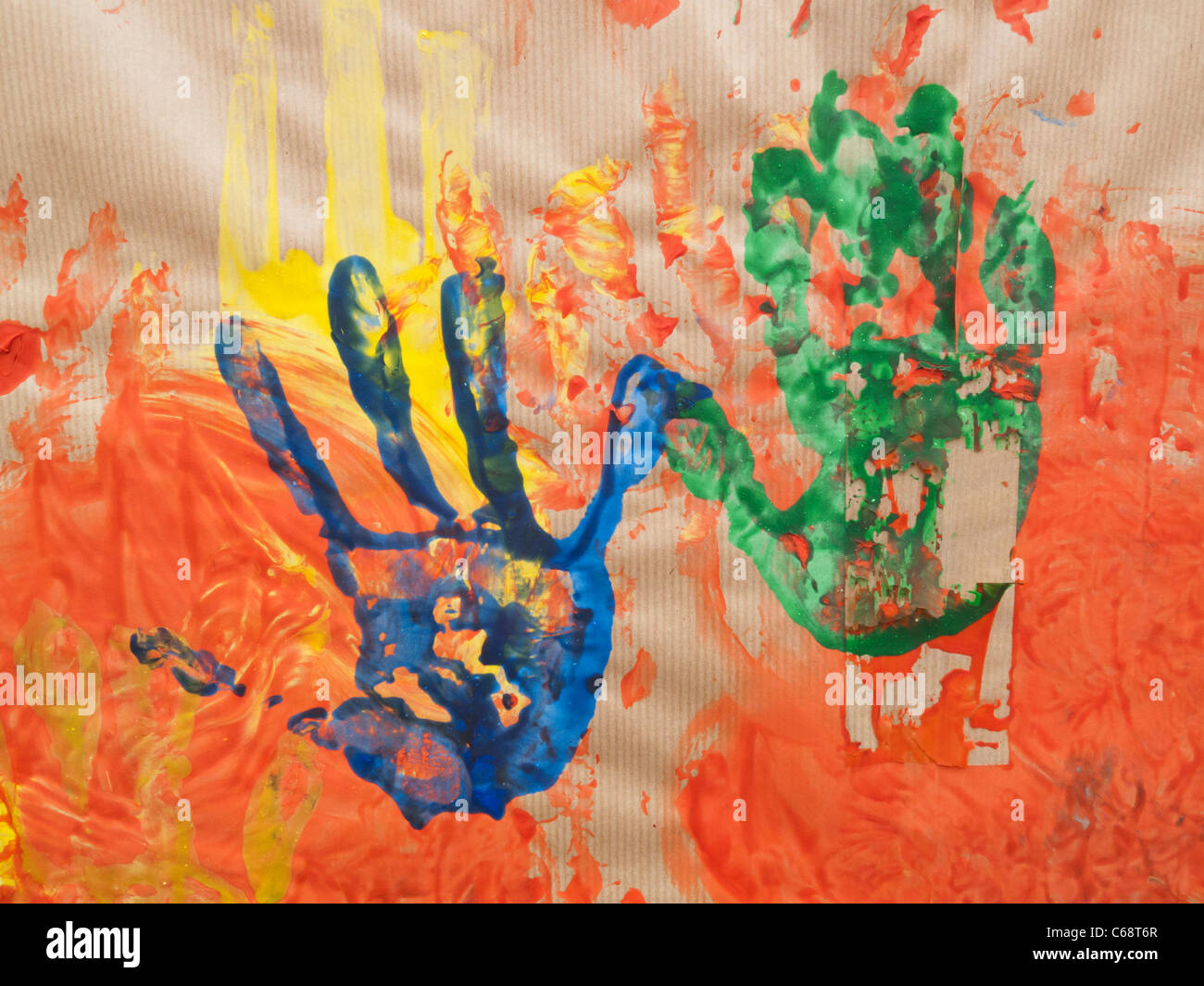 Impression of hands made with paint on brown paper Stock Photo