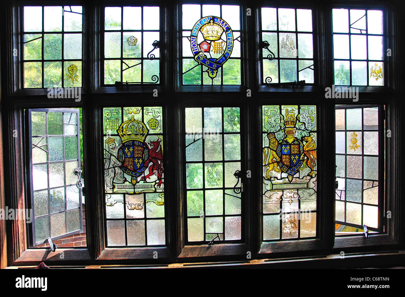 Stained glass windows in lounge, 14th-Century The Crown Inn, The Green, Chiddingfold, Surrey, England, United Kingdom Stock Photo
