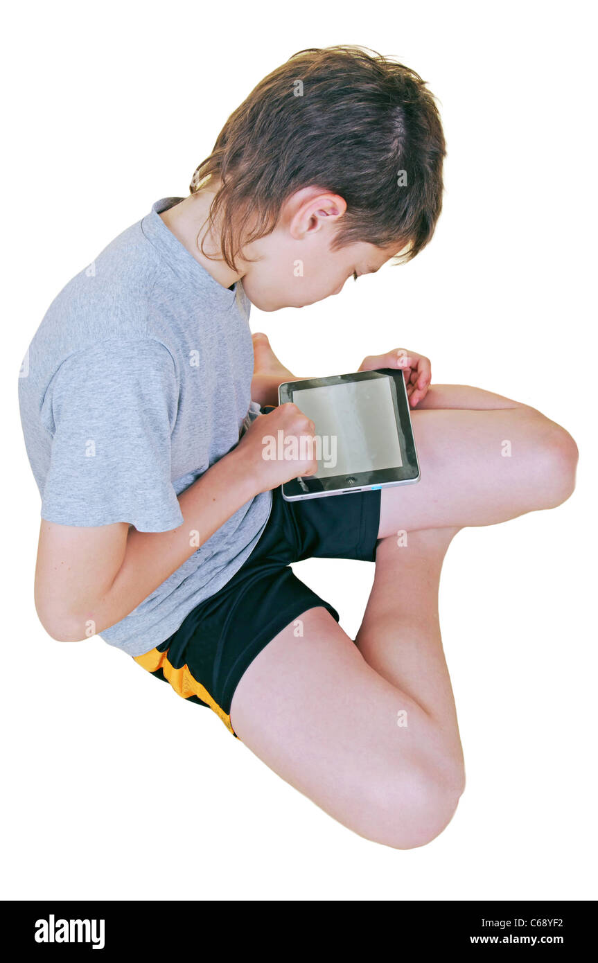 Young teen boy using electronic tablet at home Stock Photo