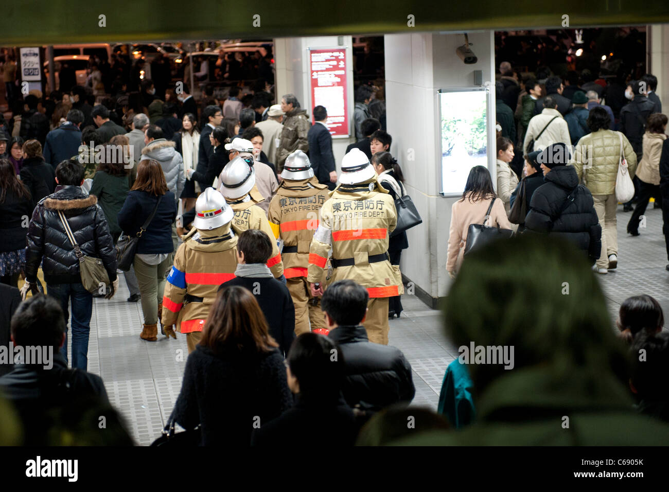Firefighters in Shinagawa station, Tokyo, 11 March 2011, following a huge earthquake in north-east Japan Stock Photo