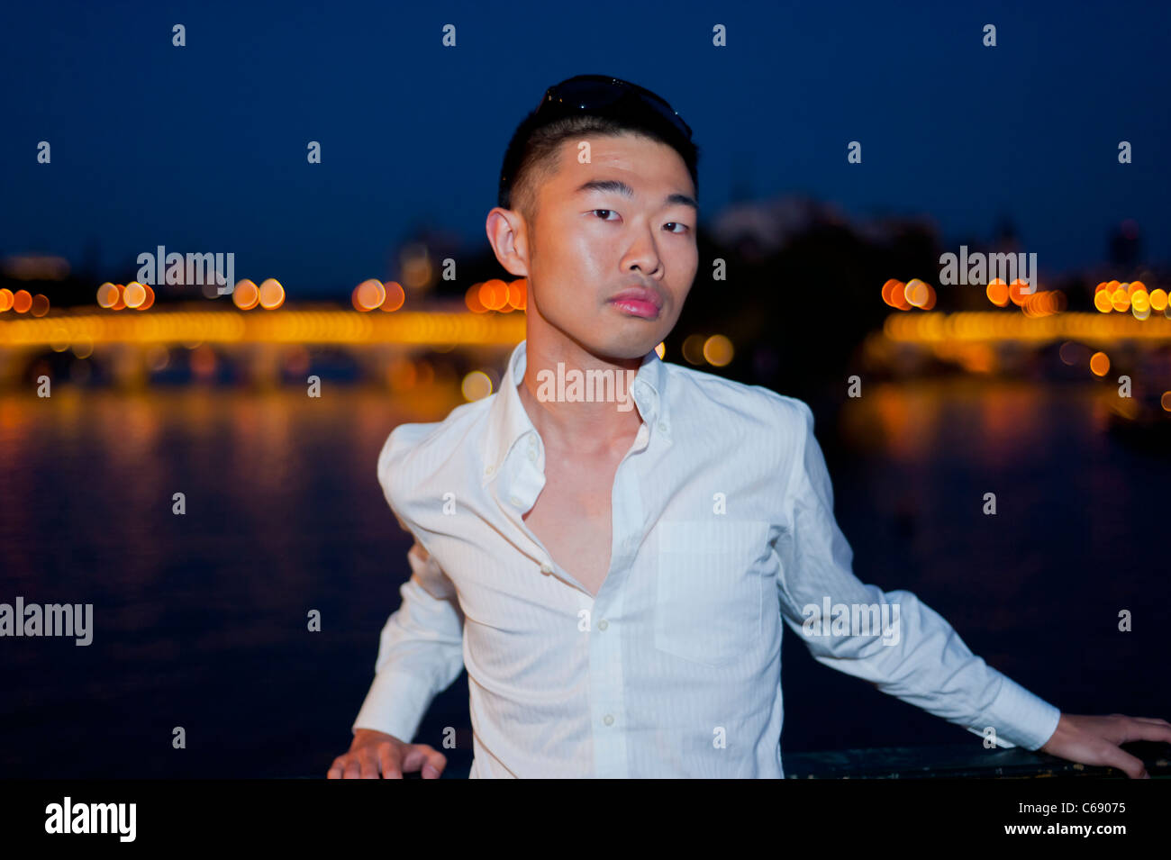 Portrait, Young Man, Chinese Outside at Night, Paris, France, man face Frontal, White Shirt Stock Photo