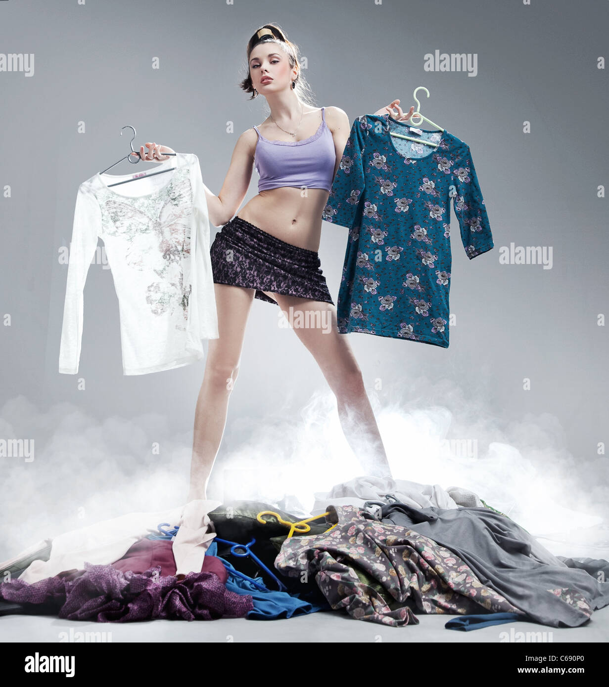 Young beautiful girl with many clothes Stock Photo