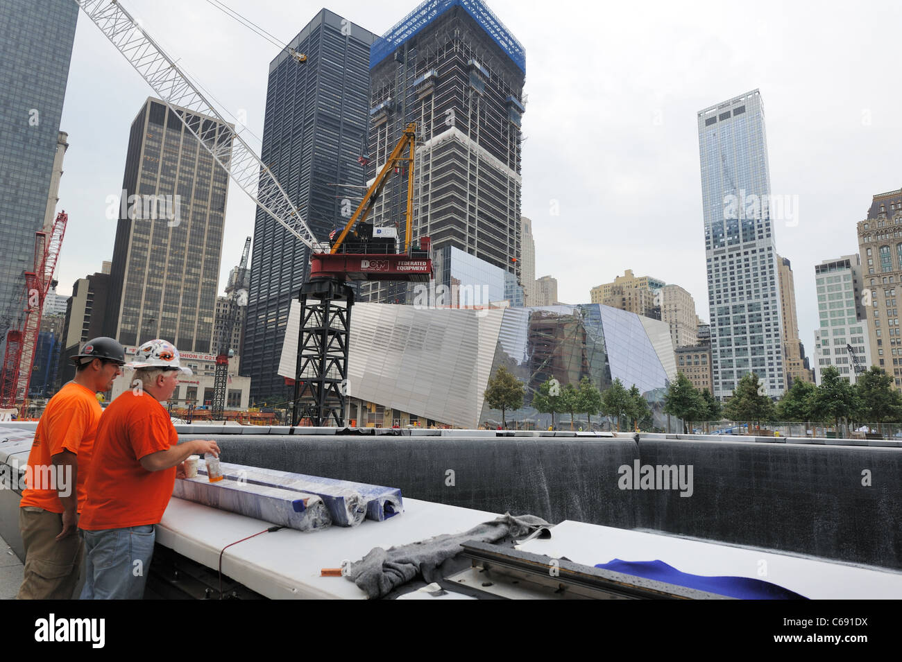 One of the two memorial pools at the World Trade Center site, with the National September 11 Museum and 4 World Trade Center. Stock Photo