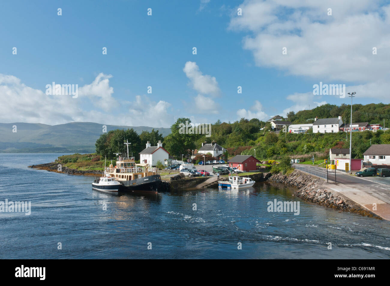 Boats beside the pier Lochaline Village with Loch Aline with Isle of Mull in background Scotland Stock Photo