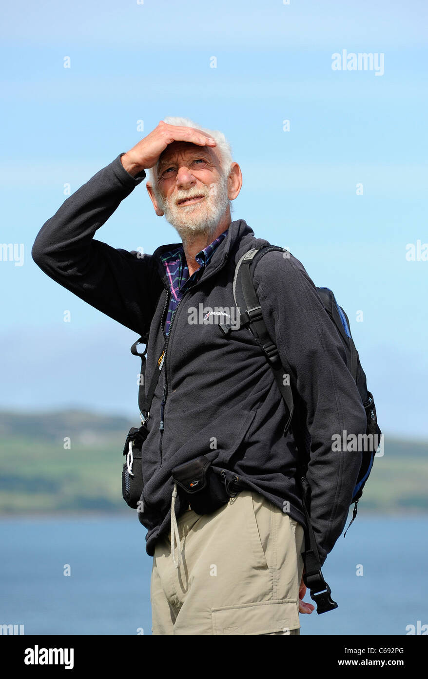 Rambler in Moelfre, Anglesey, North Wales surveys his surroundings. Stock Photo