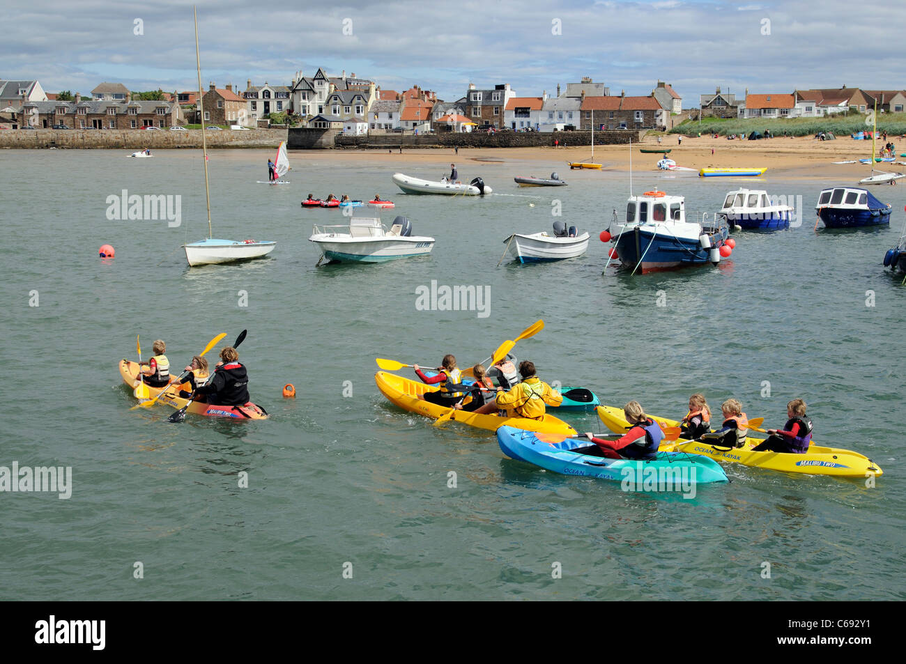 Children's holiday activities kayak race around the harbour at Elie a