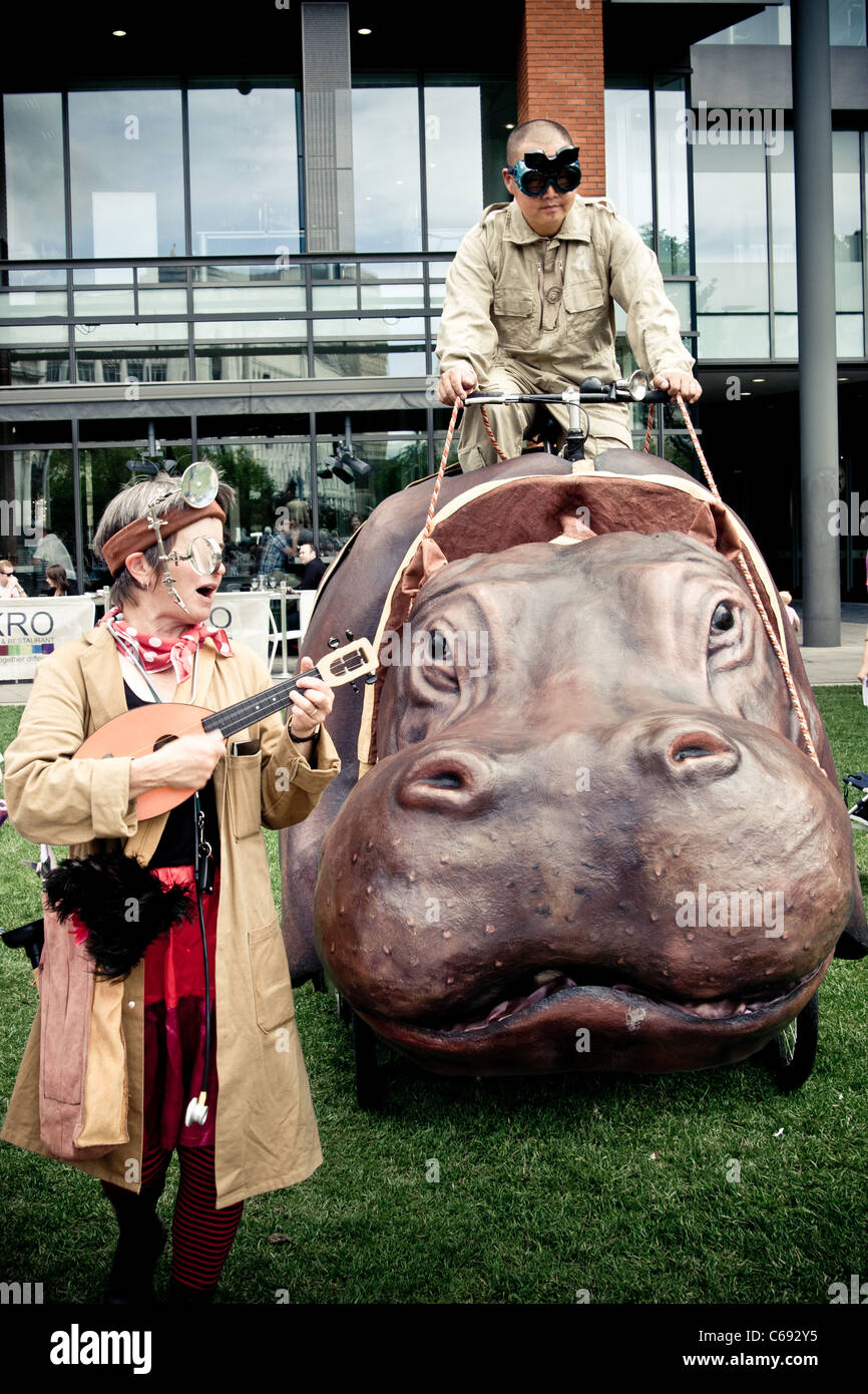 Manchester Xtrax Platform 4 event performance, fake hippo and silly characters Stock Photo