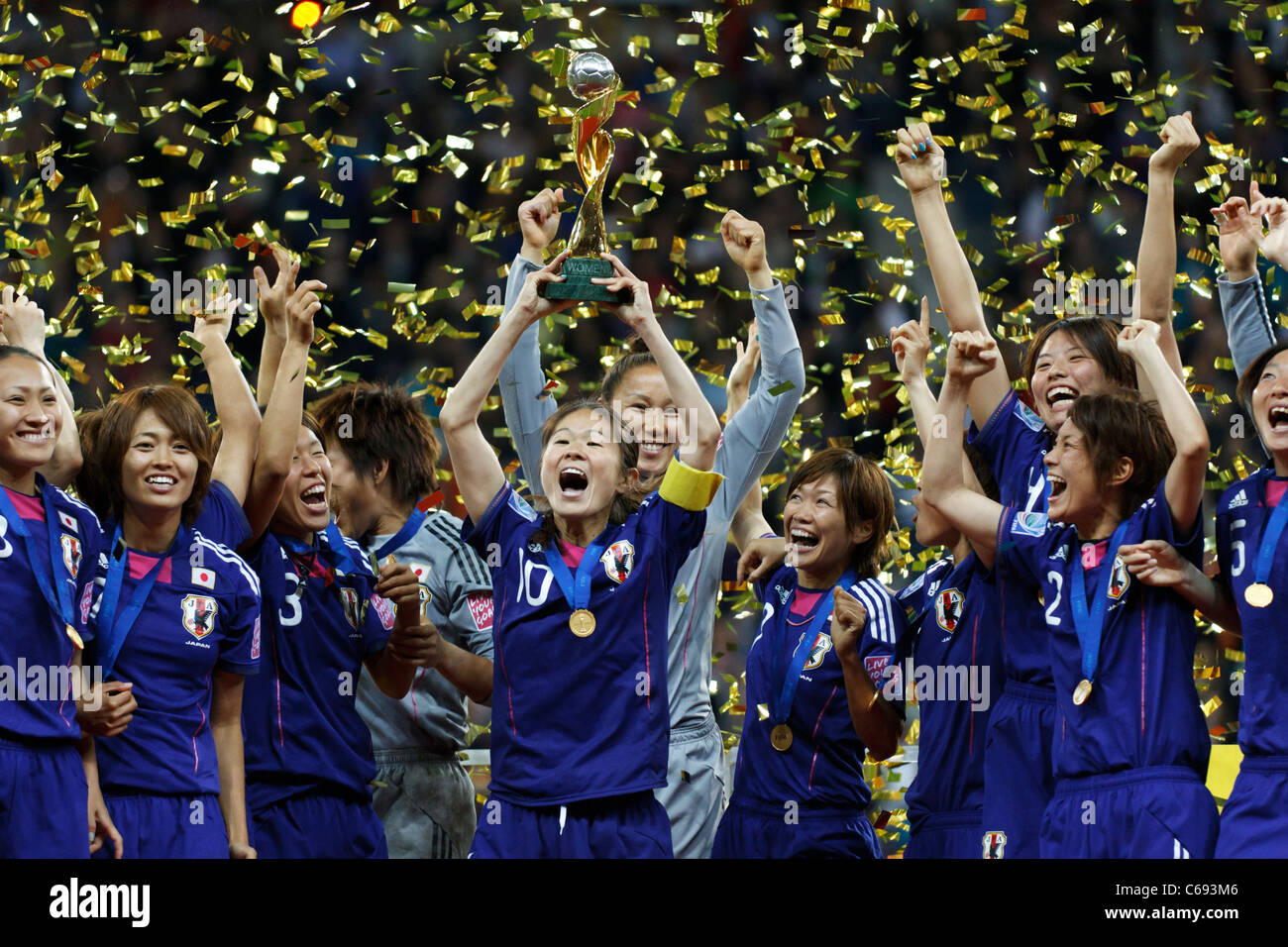 Japan team captain Homare Sawa raises the the World Cup trophy and celebrates with teammates after winning the World Cup v. USA Stock Photo