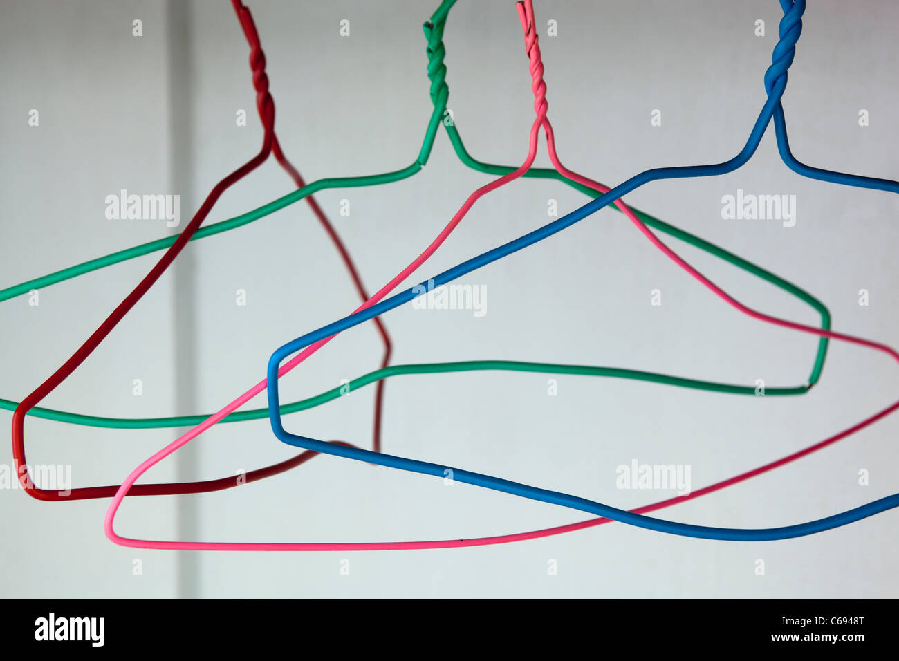 wire coat hangers hanging in wardrobe Stock Photo Alamy