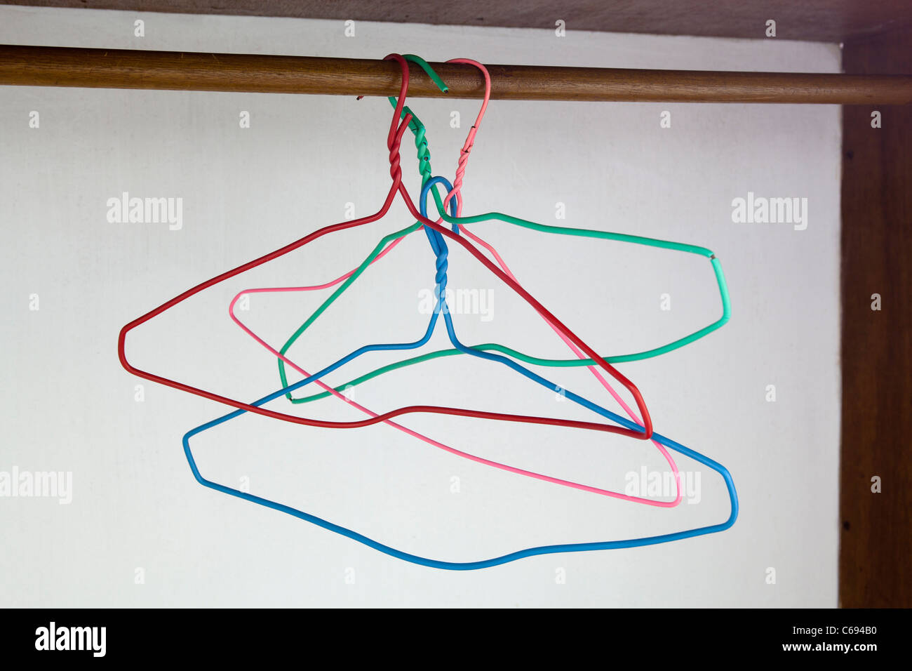 wire coat hangers hanging in wardrobe Stock Photo Alamy