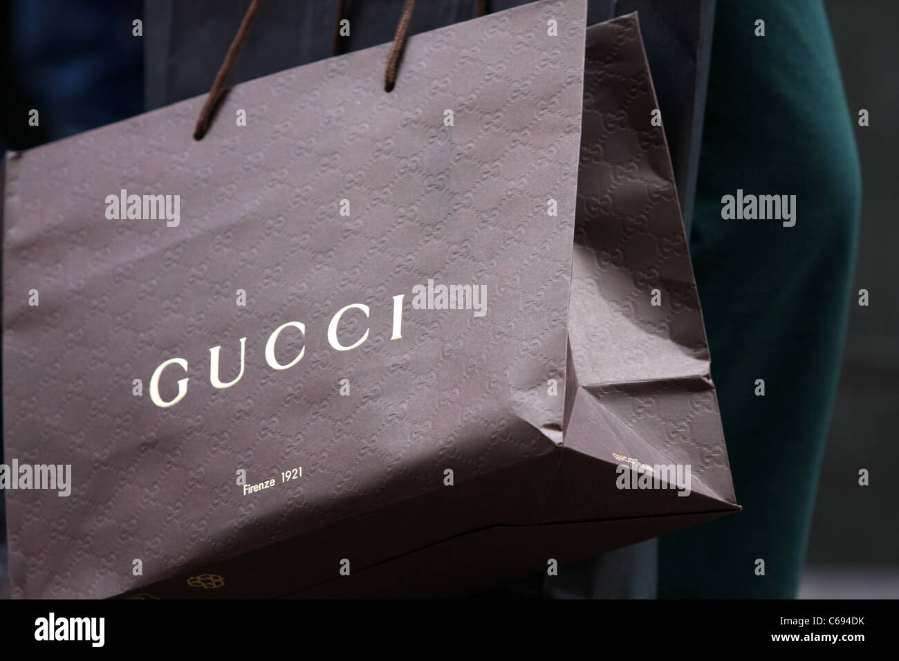 A Gucci shopping bag being carried by a shopper Stock Photo - Alamy