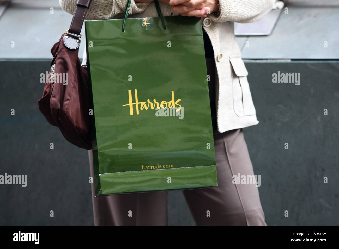 A Harrods shopping bag being carried by a shopper Stock Photo - Alamy