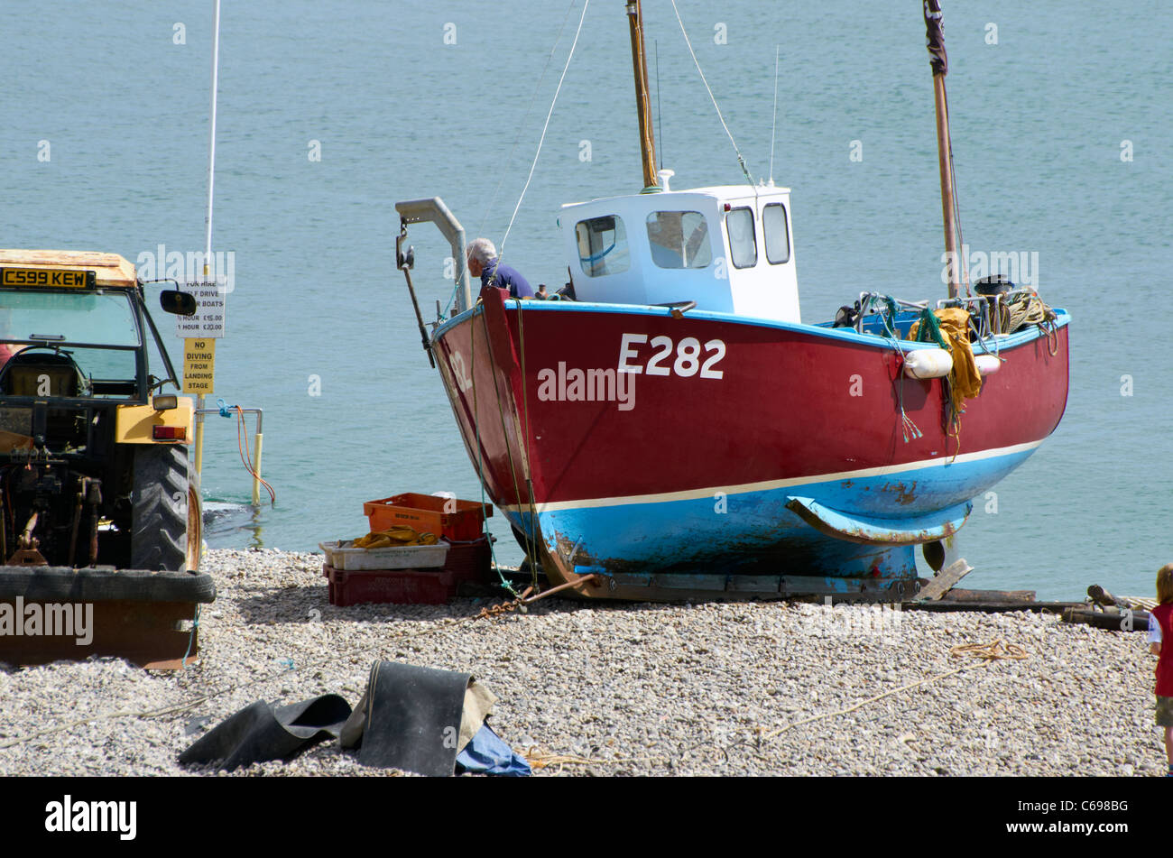 The beach at Beer, Devon, England with fishing boats, crab pots and