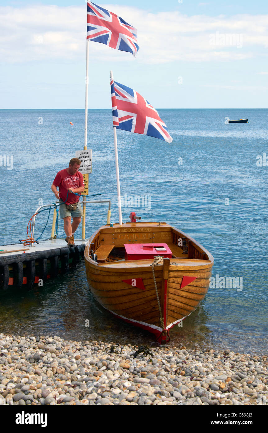 Self-drive hire boats on the beach at the village of Beer, Devon, England Stock Photo