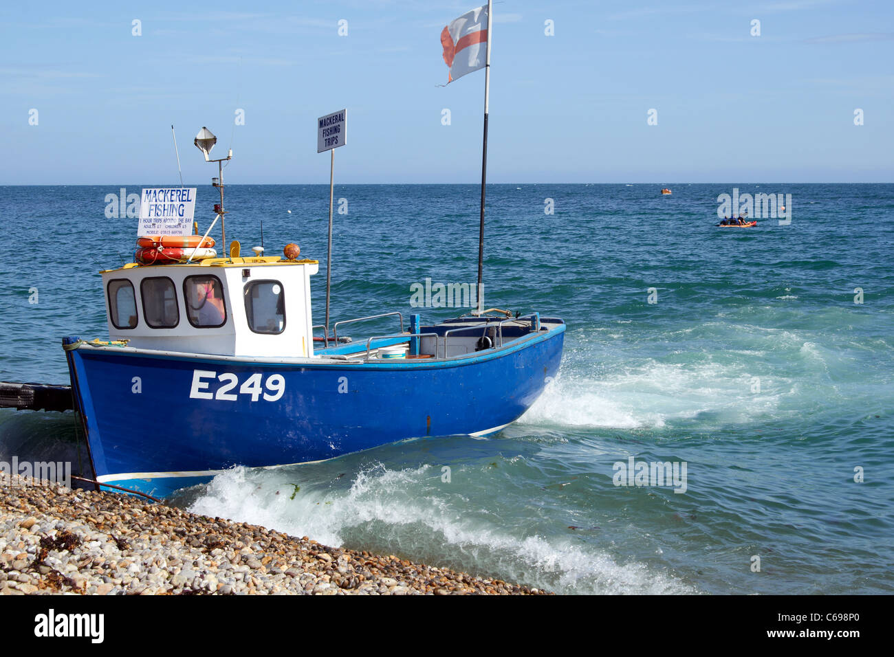 The beach at Beer, Devon, England with fishing boats, crab pots and ...