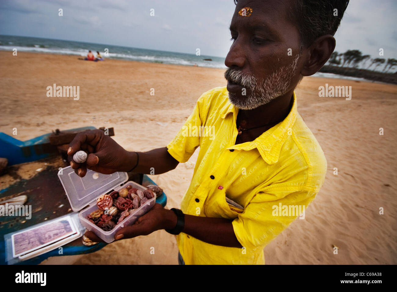 Indian fisherman selling shells on a beach Stock Photo Alamy