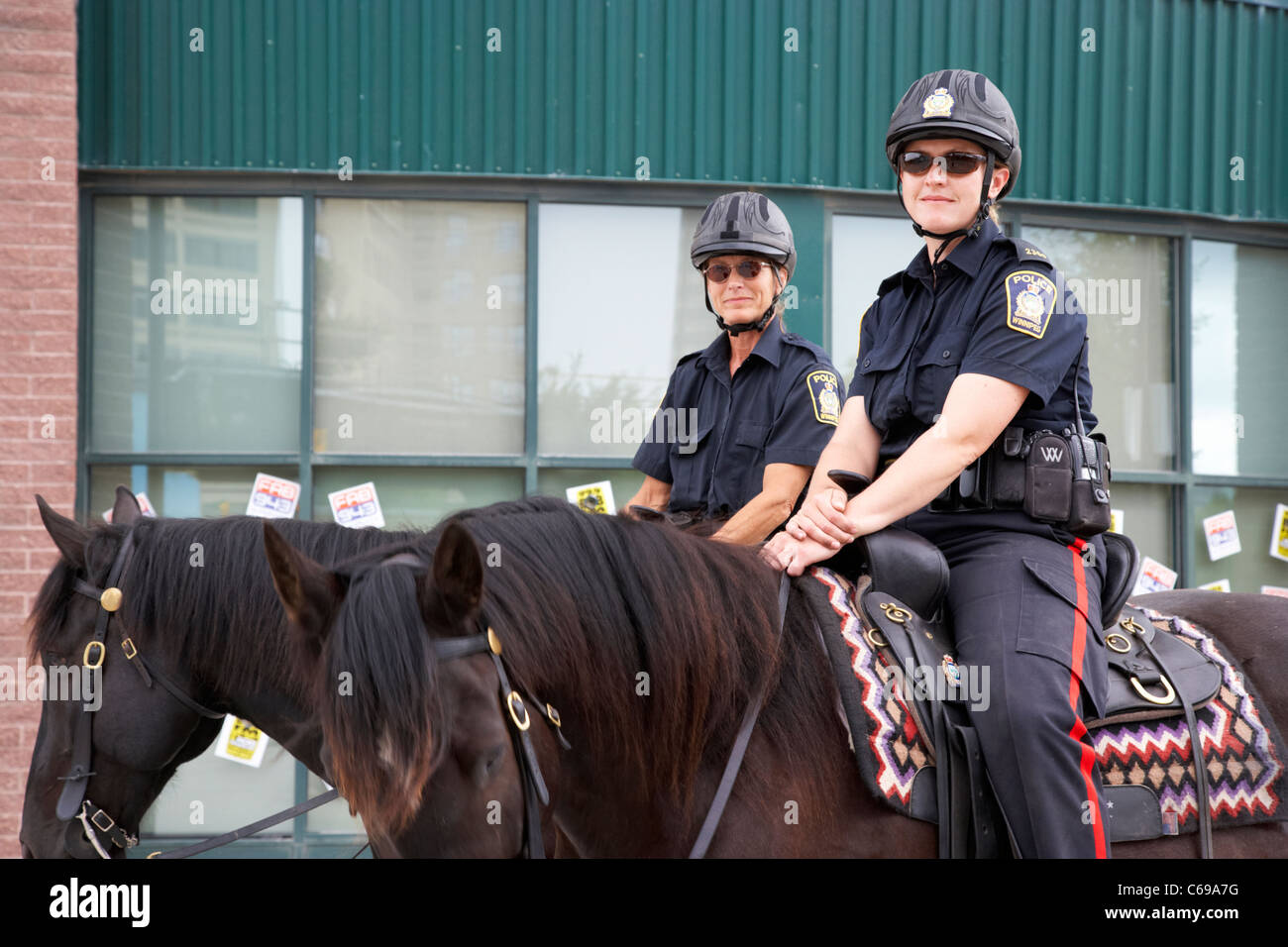 two female winnipeg police officers on horseback in Winnipeg Manitoba Canada Stock Photo