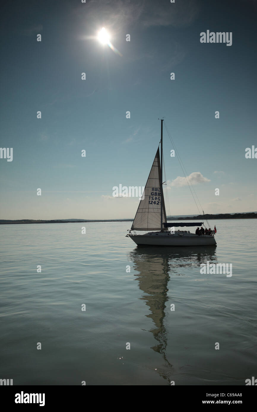 Yacht sailing on calm water Stock Photo