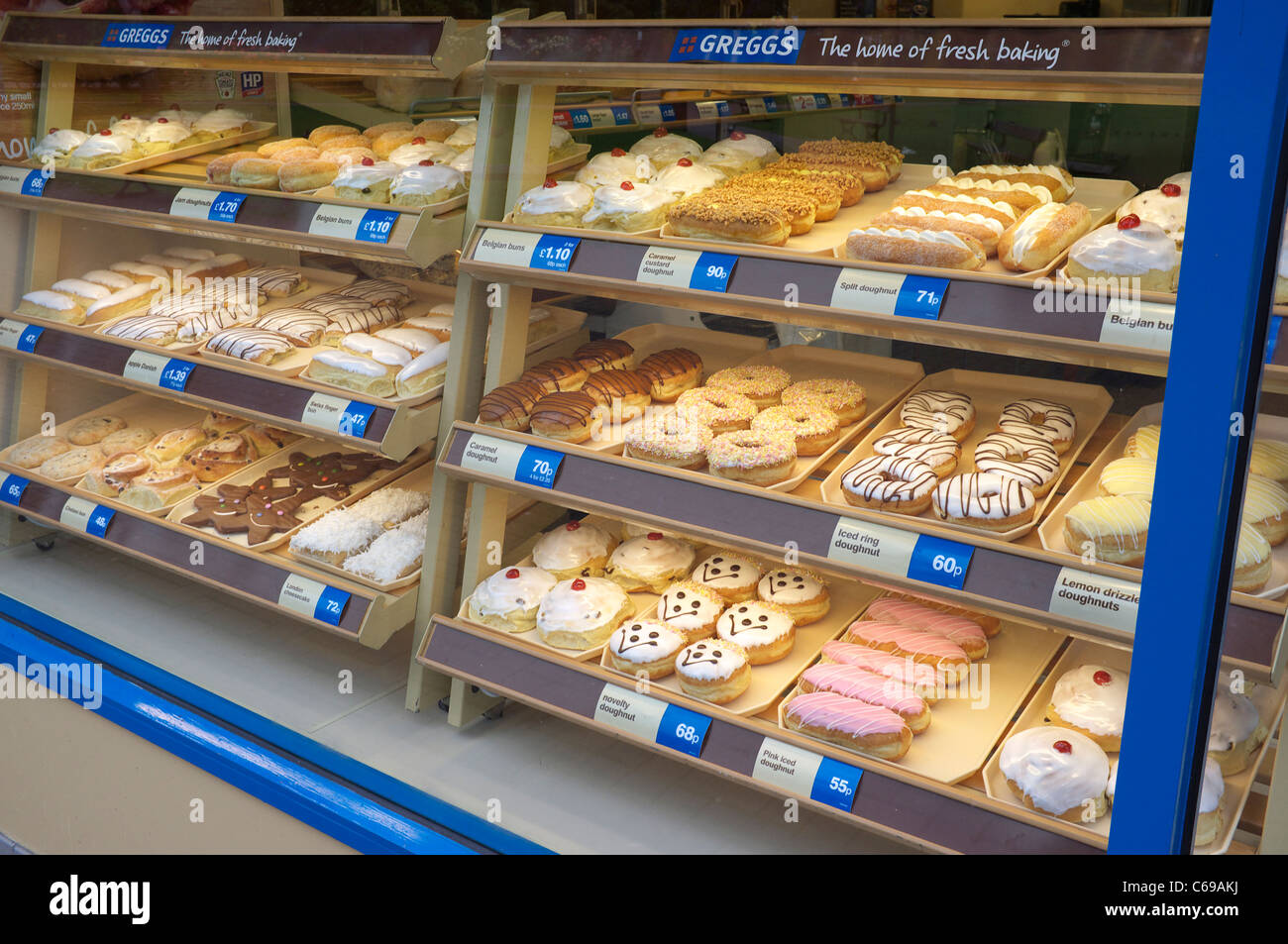 Cakes for sale in a bakers shop window Stock Photo Alamy