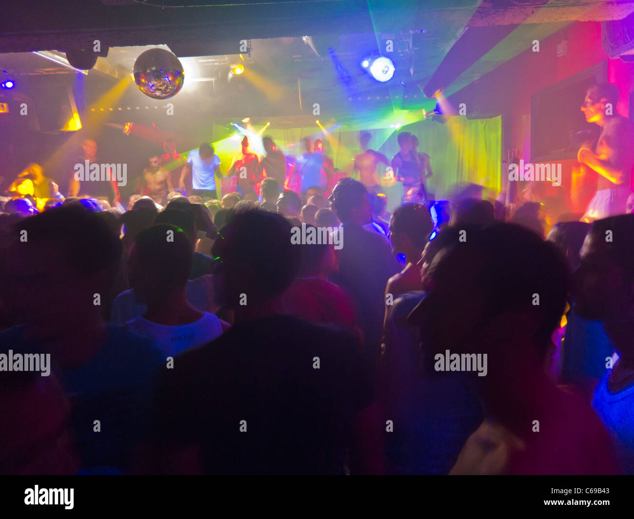 Paris, France, Large Crowd People inside Gay Night club, Scream, Adult Men dancing on Crowded Dance Floor haze, Light Effects, Hazy Smoke Stock Photo