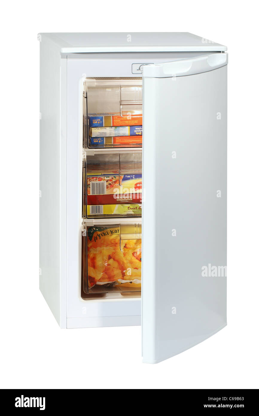 White undercounter freezer full of various frozen foodstuff isolated on white. Stock Photo