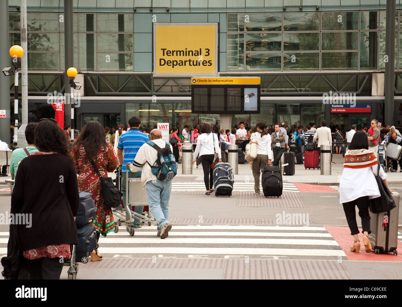 Passengers at the entrance to terminal 3, Heathrow airport London UK Stock Photo