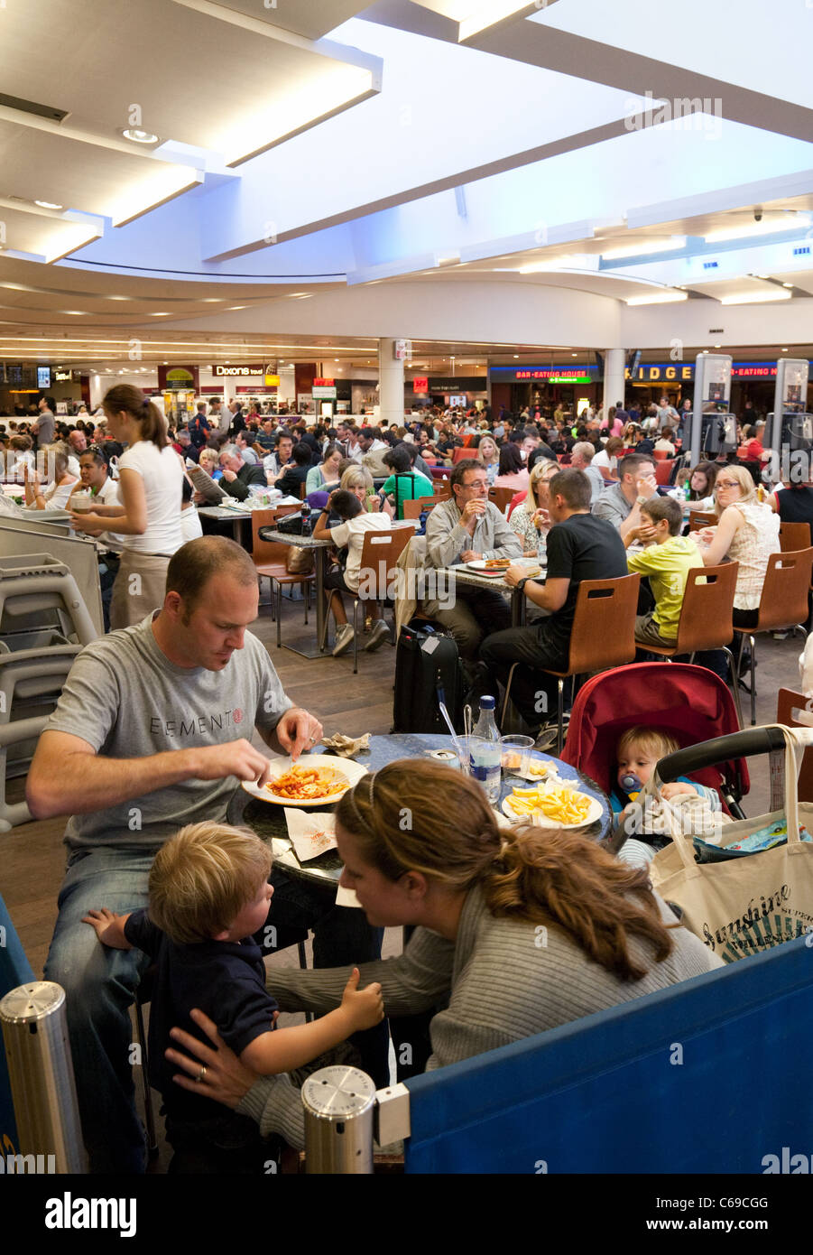 Crowds of people waiting in the departure lounge, terminal 3, Heathrow airport London UK Stock Photo