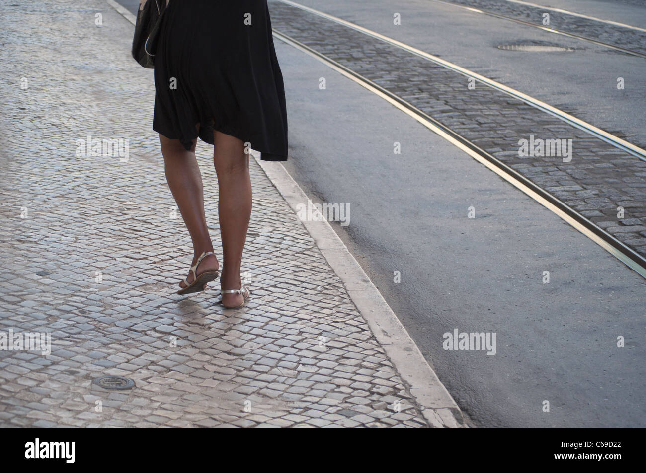 Woman walking in Lisbon pavement, Portugal Stock Photo
