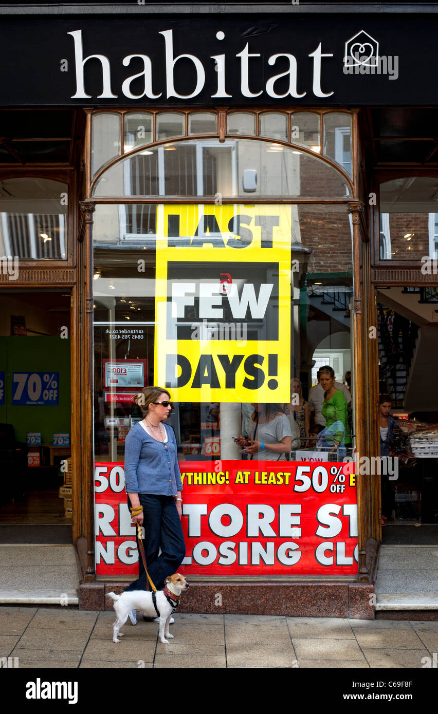 Woman and her dog stand outside a Habitat store in York, England that