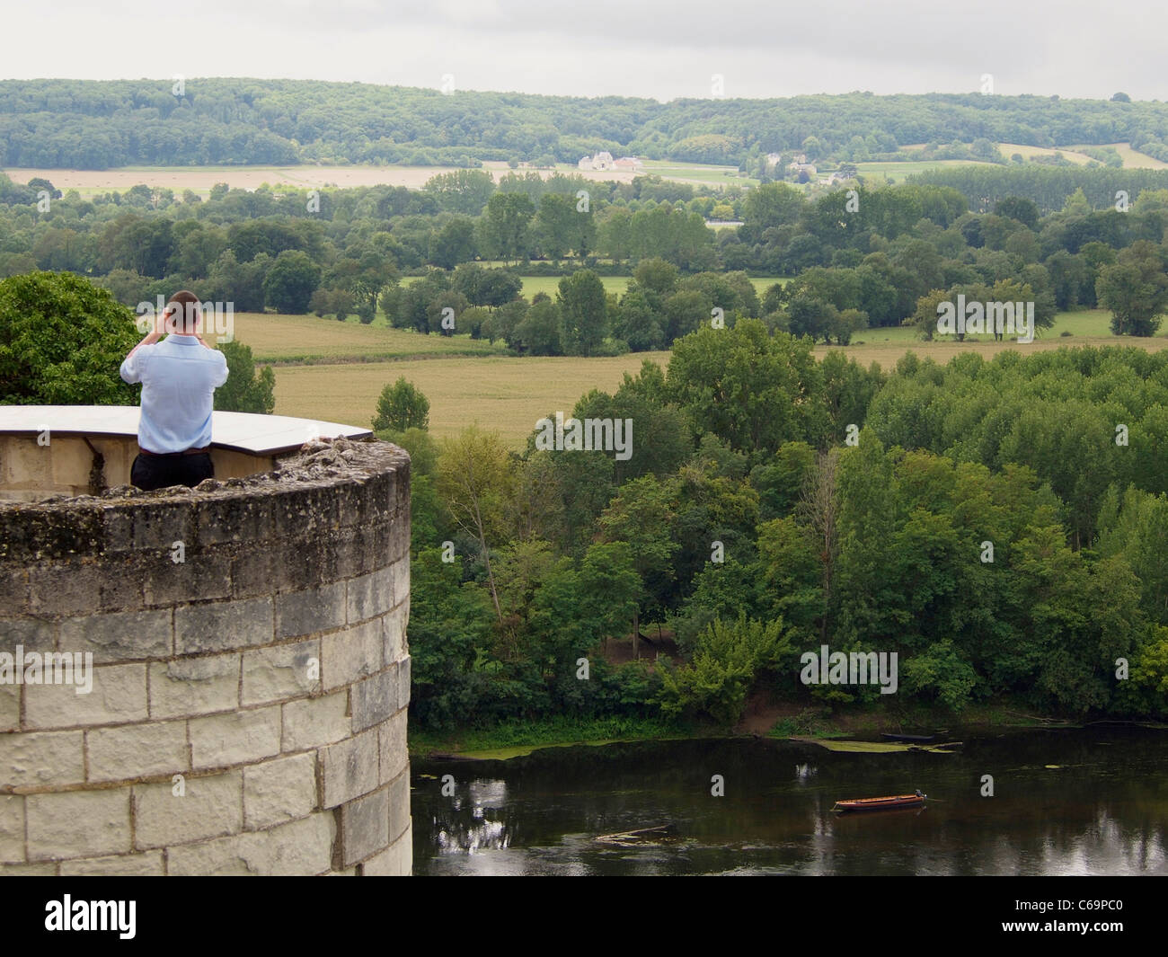 Tourist taking a picture of the Loire valley landscape from the castle of Chinon, France Stock Photo