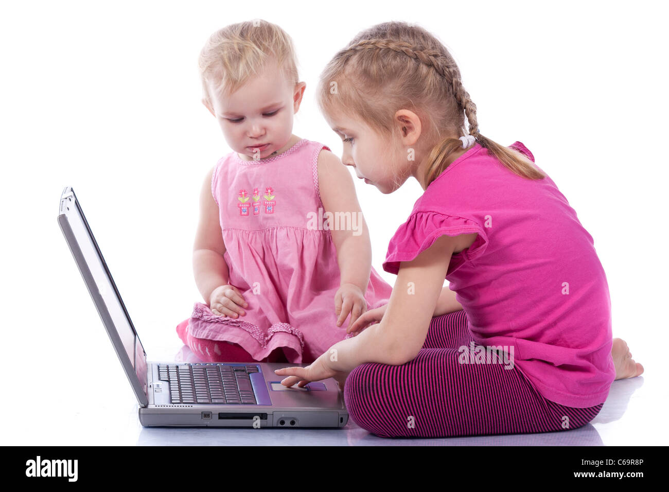 Kids playing computer game on laptop isolated on white Stock Photo