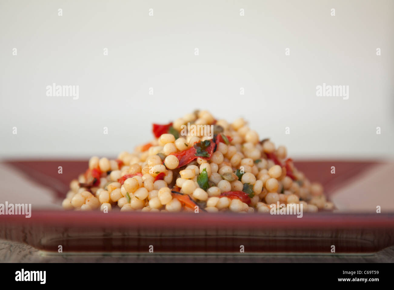 Giant Couscous on a plate Stock Photo Alamy