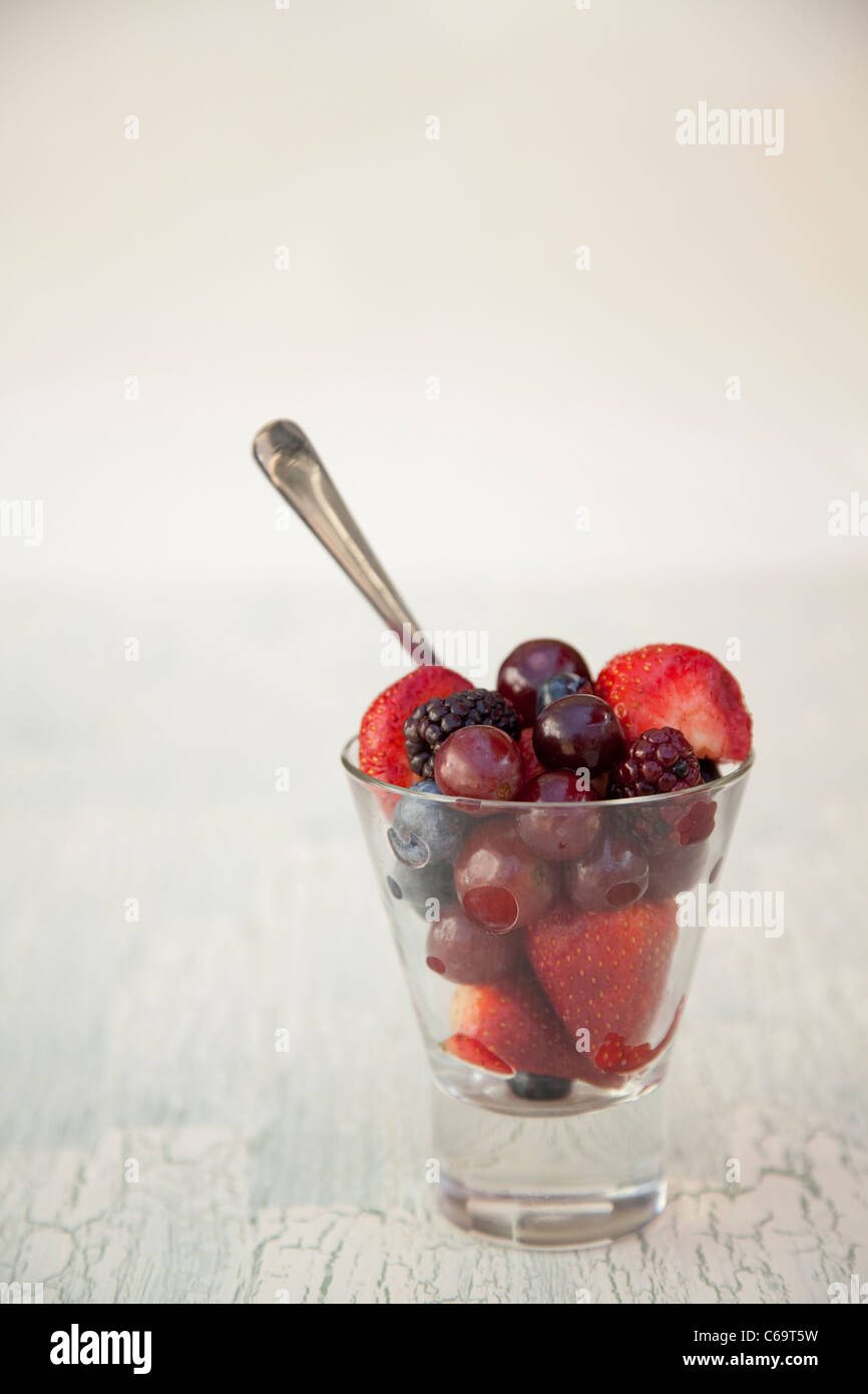 Strawberries, blackberries, grapes and blueberries in a glass, with