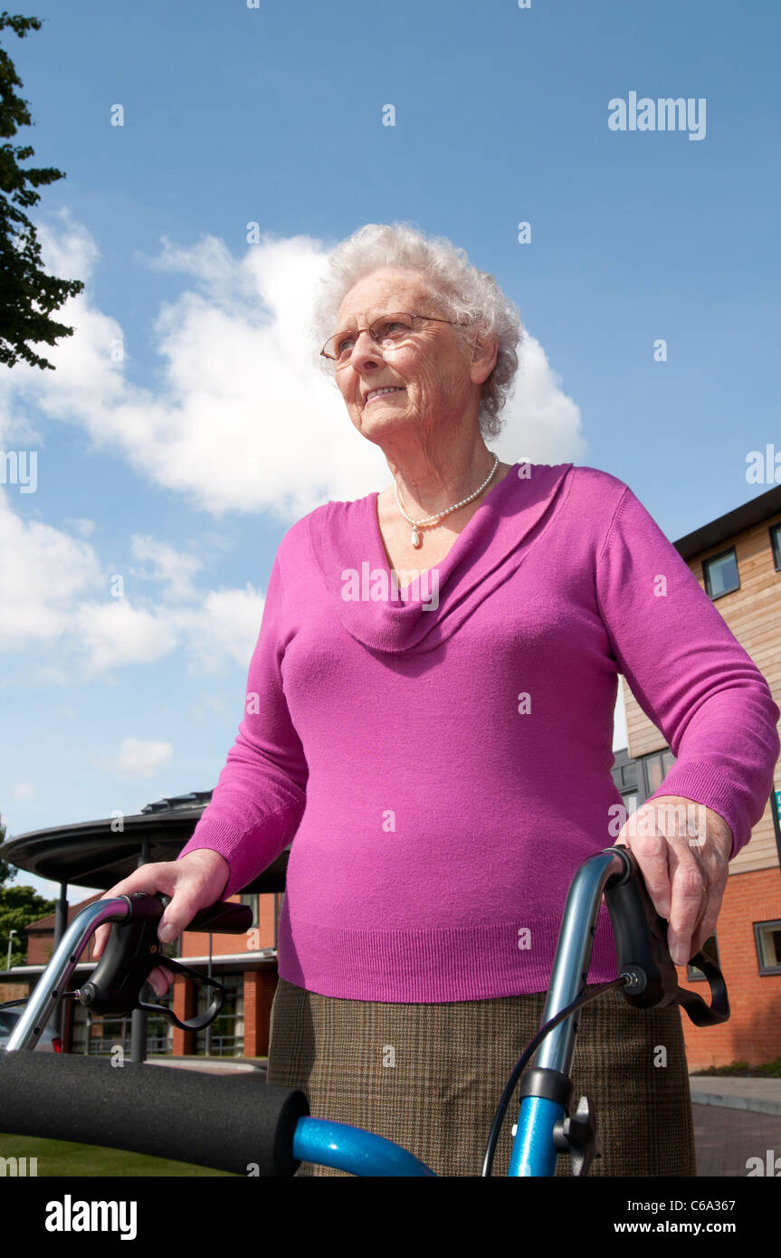 Elderly women uses walking aid Stock Photo - Alamy